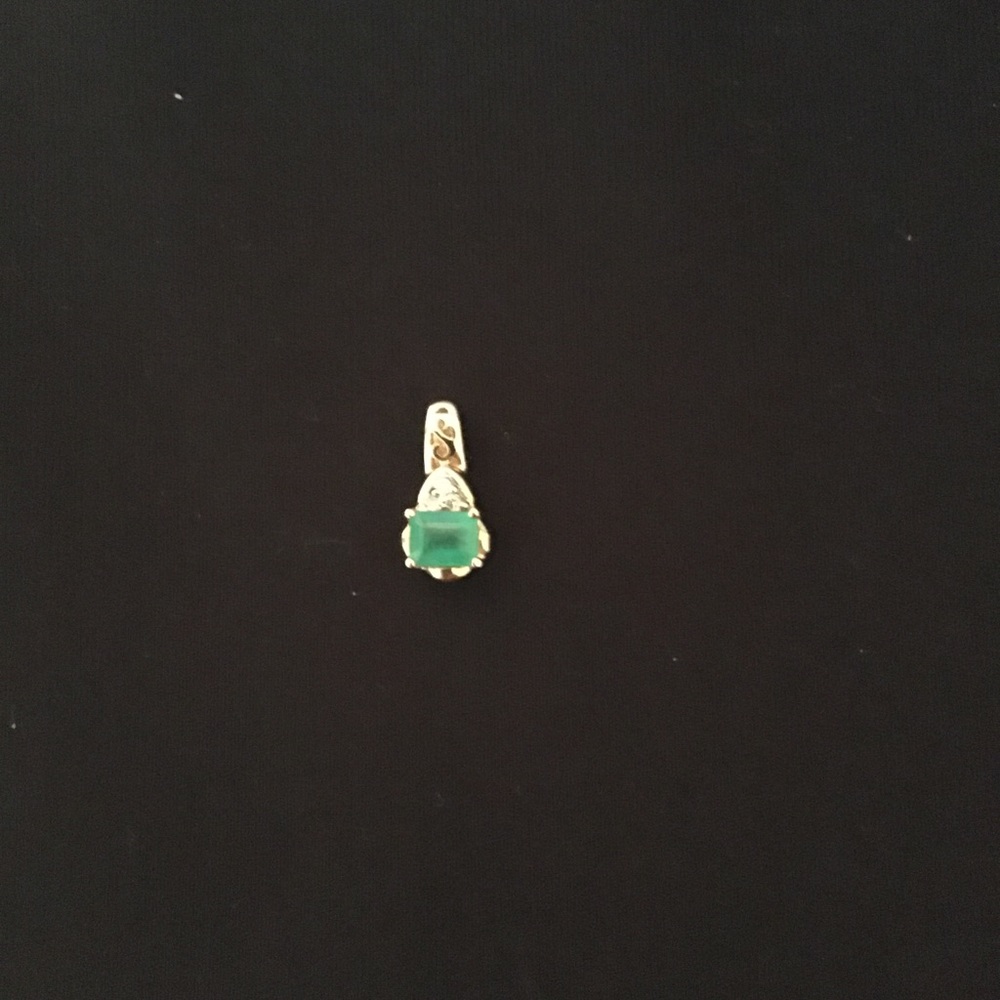 Ladies Emerald cut .25 ct emerald set in 14kt gold